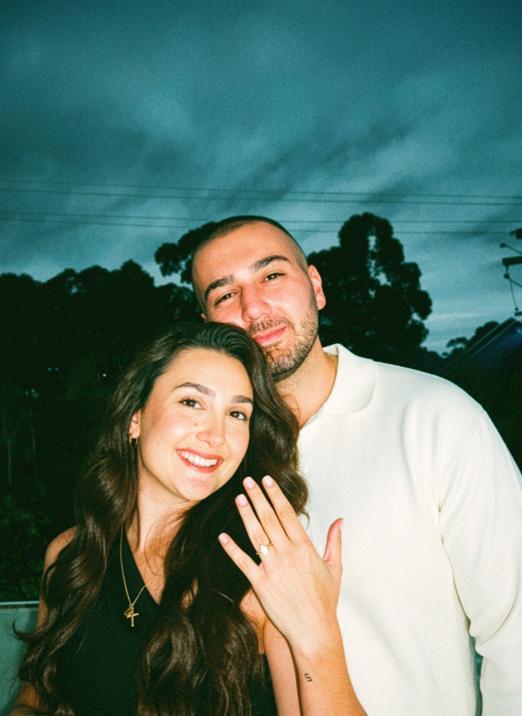 David and Gareene, newly engaged, Gareene showing her ring at dusk